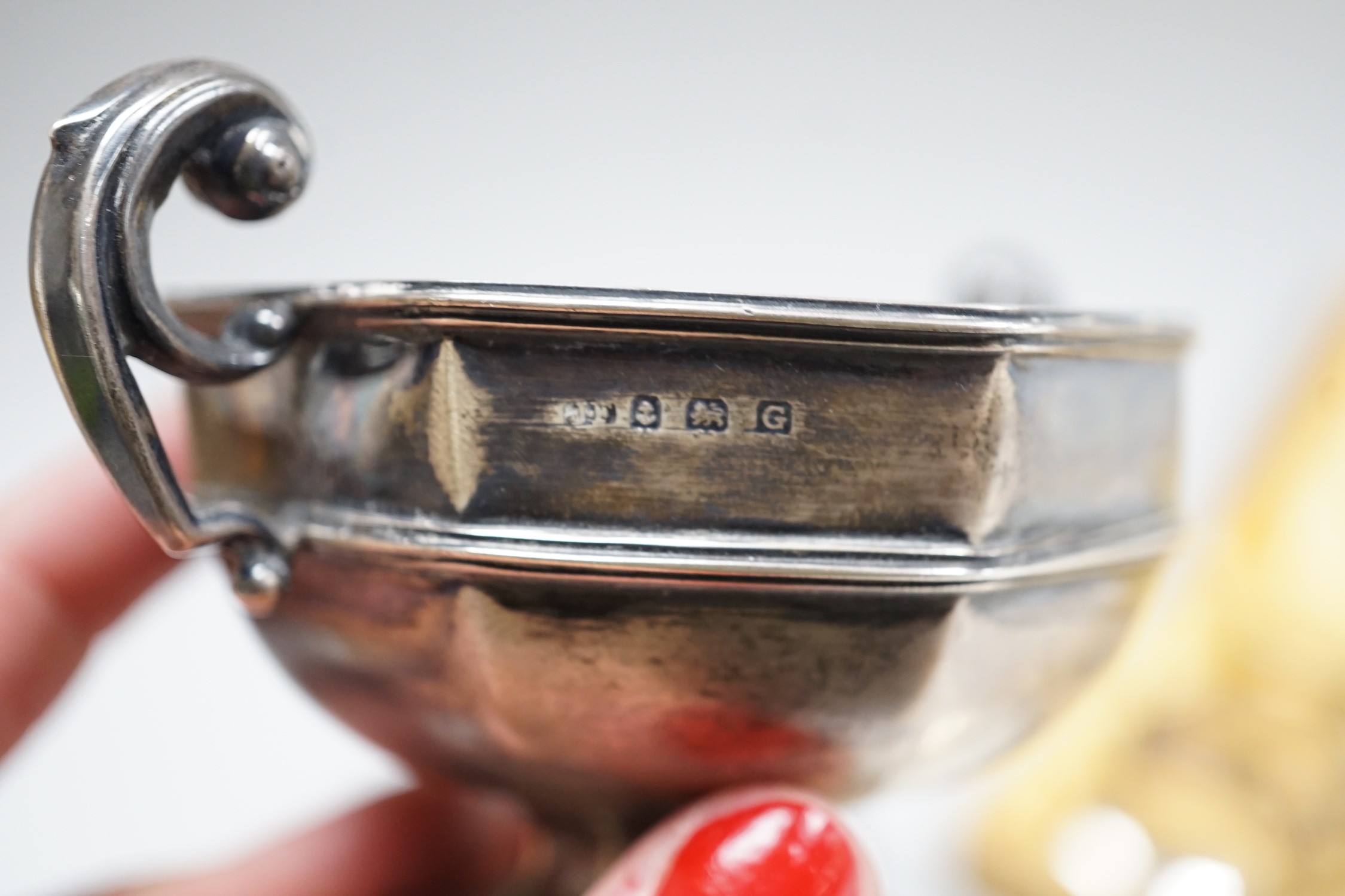 A late Victorian silver vesta case, a silver pill box, a small silver trophy cup, a cased set of six Swedish white metal coffee spoons, a similar spoon and fork and an early 20th century tow colour white metal fob watch.